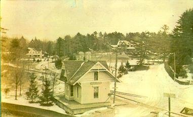 A sepia-toned photograph of a Bear Creek train depot surrounded by snow-covered grounds and trees, documenting Bischwind Villa history.